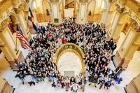 Many people gathered around the banister and halls of the Colorado State Capitol.